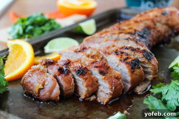 Grilled Peanut-Lime Pork Tenderloin 3 Close-up of perfectly grilled pork tenderloin slices with a rich glaze