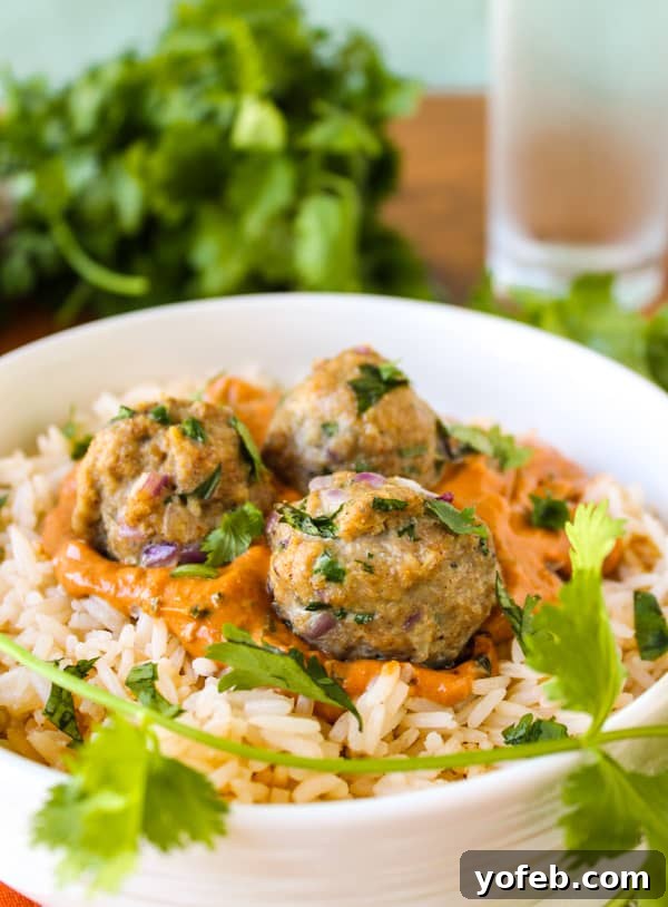 Creamy Chicken Tikka Meatballs 3 Close-up of baked chicken meatballs, perfectly golden brown before being added to the sauce, showcasing their tender texture.