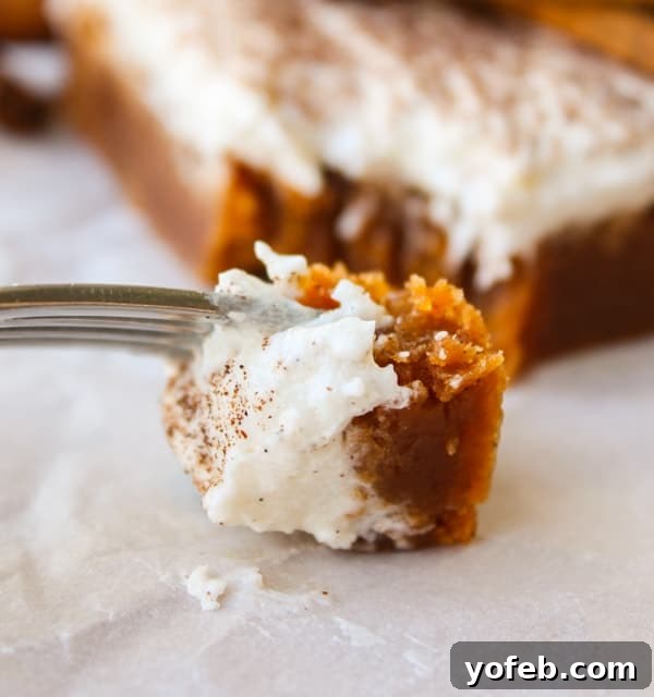 A close-up of the Butterscotch Pumpkin Cake, emphasizing its gooey texture and generous frosting