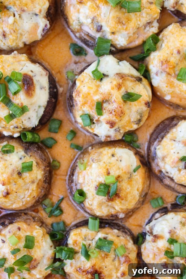 Blazing Blue Cheese & Bacon Stuffed Mushrooms 3 Close-up of freshly baked Bacon Blue Cheese Stuffed Mushrooms, perfectly browned and ready to serve as a party appetizer.
