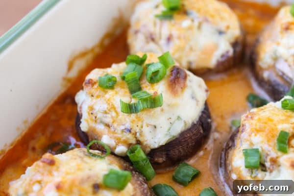 Blazing Blue Cheese & Bacon Stuffed Mushrooms 5 Side view of freshly baked Bacon Blue Cheese Stuffed Mushrooms, showcasing their golden-brown tops and rich, creamy filling.
