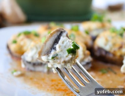 Blazing Blue Cheese & Bacon Stuffed Mushrooms 6 Prepared filling for Bacon Blue Cheese Stuffed Mushrooms being spooned into mushroom caps.