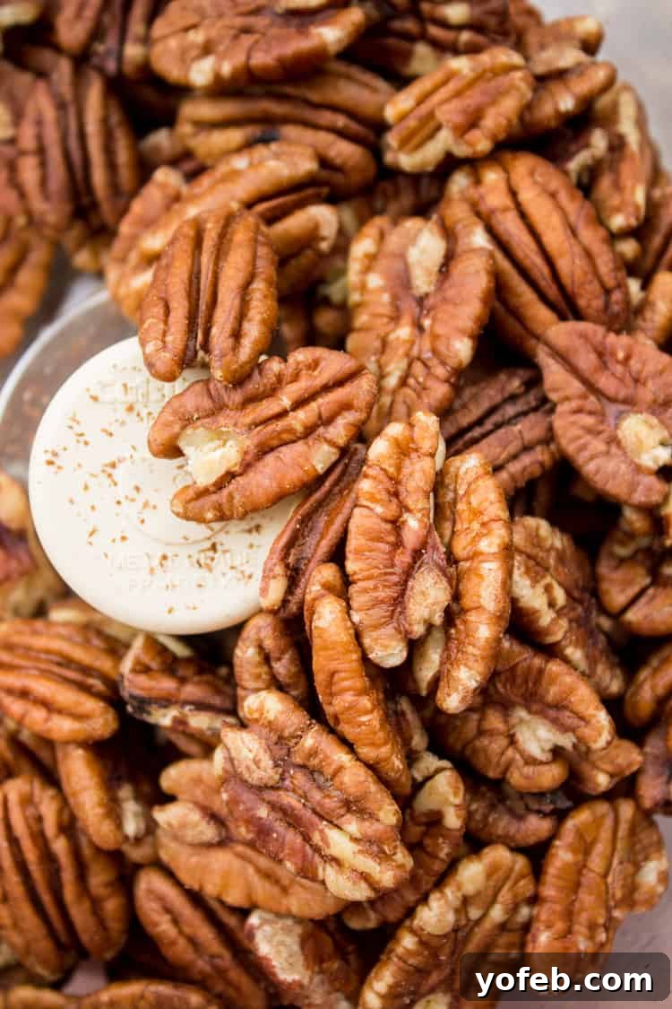 Whole pecans being processed into fine pieces in a food processor.