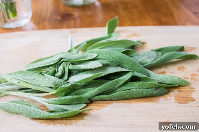 Herbal Roasted Turkey Delights 9 Fresh sage leaves, vibrant green and aromatic, neatly arranged on a rustic wooden cutting board.