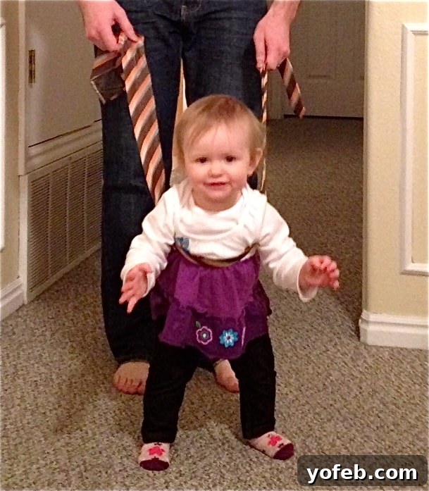 Char walking Baby walking with the help of a tie.