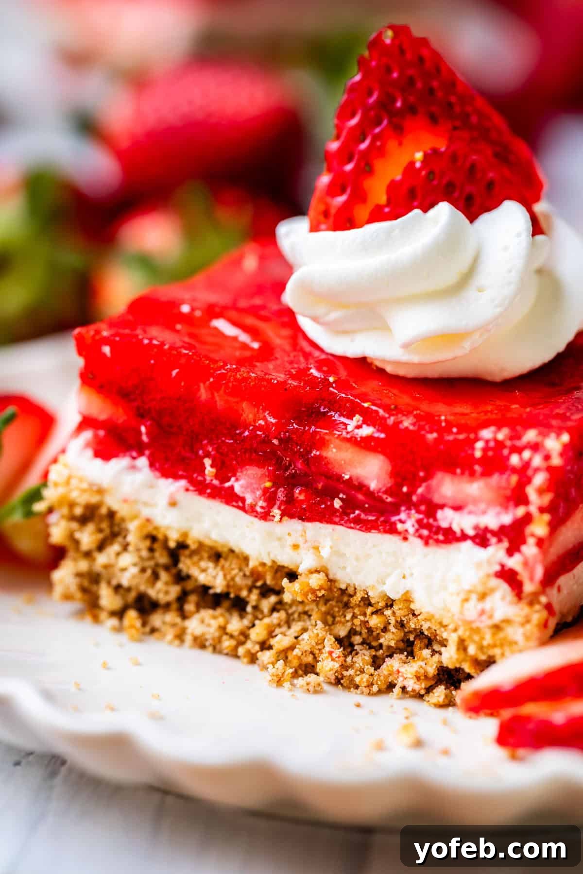 Sweet & Salty Pretzel Delight 3 a slice of strawberry jello pretzel salad.