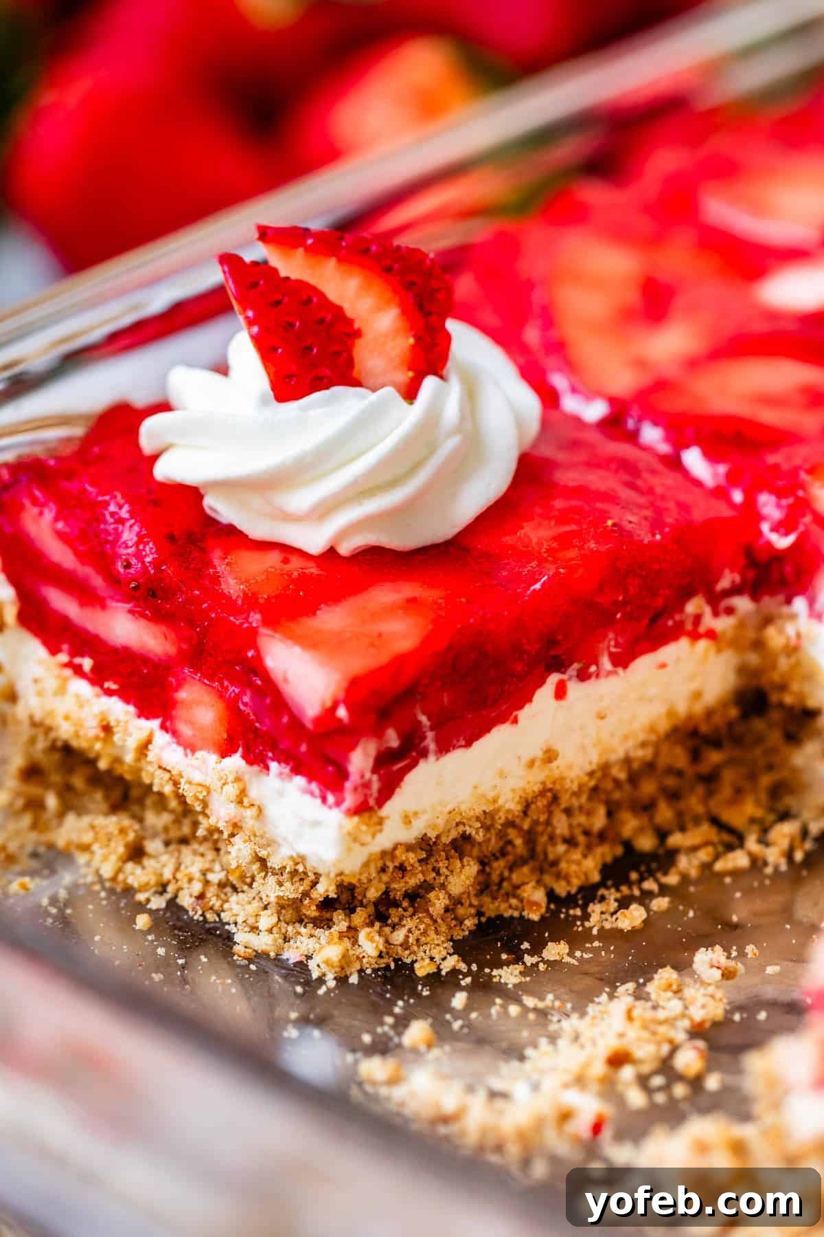 Sweet & Salty Pretzel Delight 5 a slice of strawberry jello pretzel salad in a pan.