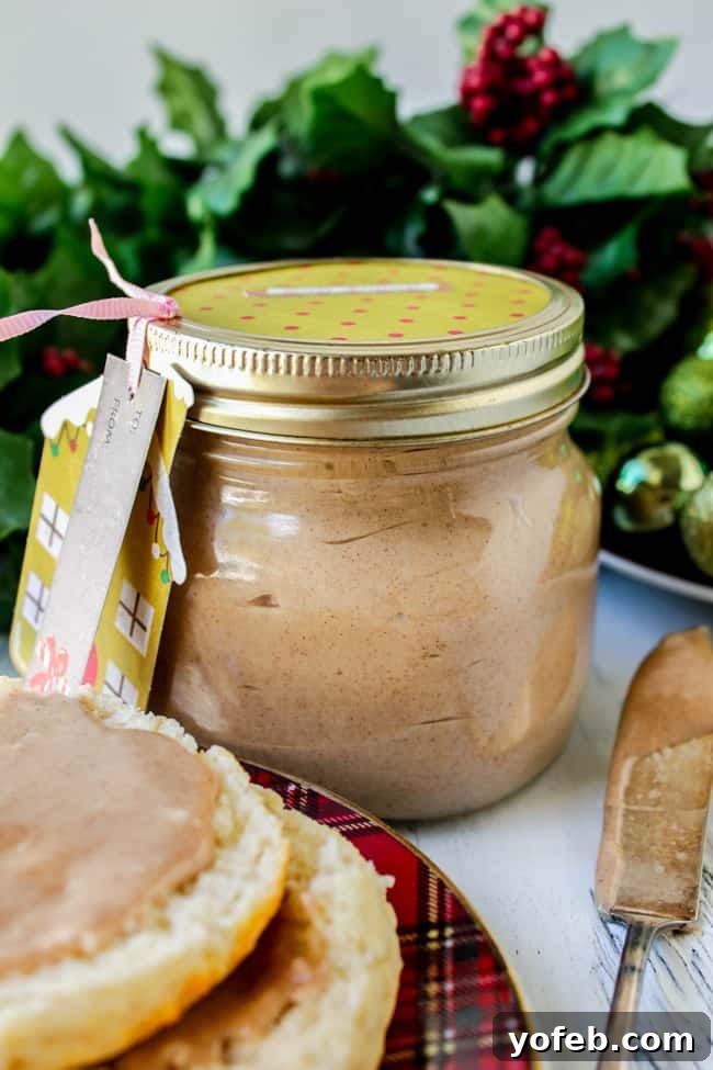 Spiced Honey Butter Delight 4 A festive mason jar of cinnamon honey butter, decorated with a Christmas gift tag and ribbon, perfect for gifting.