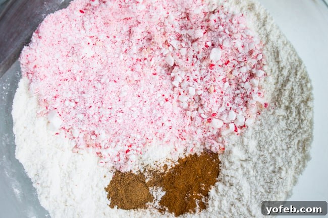 Peppermint Gingerbread Bars cooling on a rack, showing the crunchy texture of the candy cane pieces in the dough.