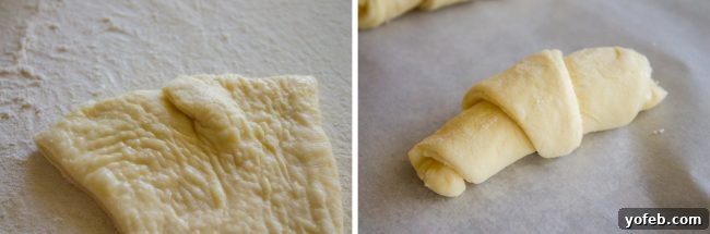 Technique for Rolling Crescent Rolls A close-up of a partially rolled crescent roll, demonstrating the technique of snipping and folding the wide end to adjust its length.