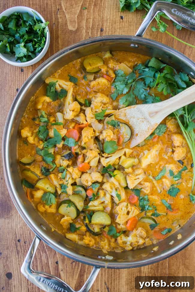 Effortless 6-Ingredient One-Pot Vegetable Curry 3 A close-up of a large pot filled with a creamy, rich vegetable curry, simmering gently, showcasing the colorful vegetables.