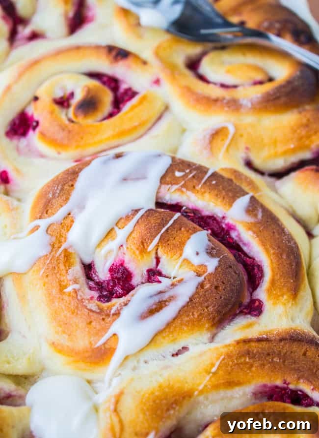 Soft, fluffy Raspberry Sweet Rolls with generous Coconut Cream Cheese Frosting, a perfect Valentine's Day breakfast.