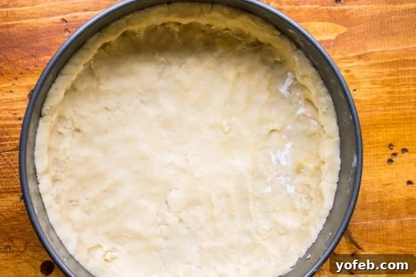 Bright Meyer Lemon Curd Tart on a Golden Shortbread Crust 5 A golden shortbread crust, perfectly pressed into a springform pan, ready for baking.