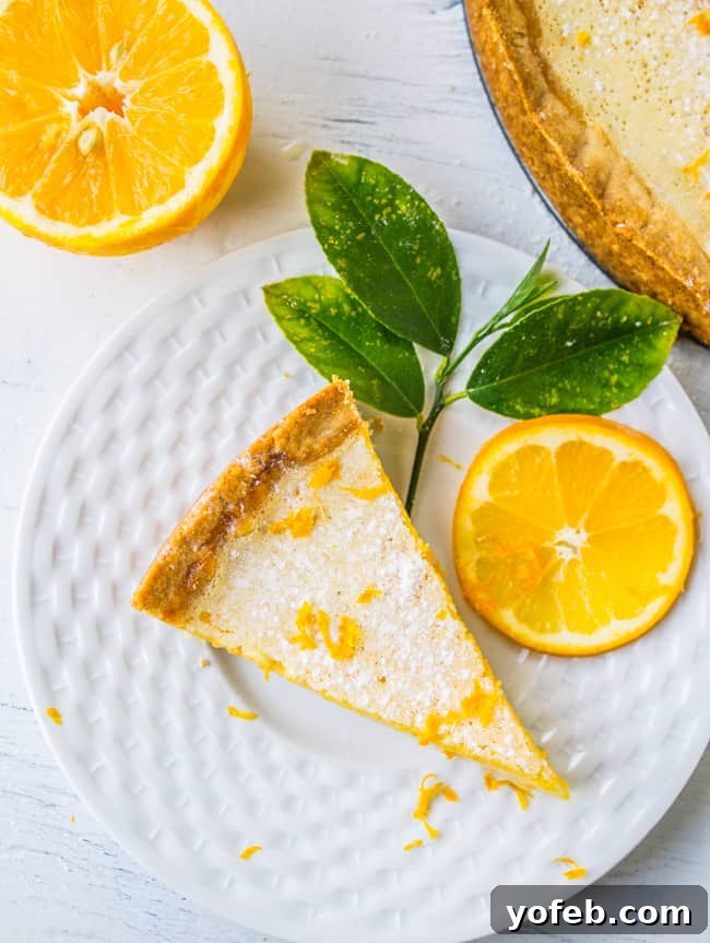 Bright Meyer Lemon Curd Tart on a Golden Shortbread Crust 6 A beautiful slice of Meyer lemon tart artfully arranged on a plate, garnished with fresh lemon leaves and a delicate slice of Meyer lemon.