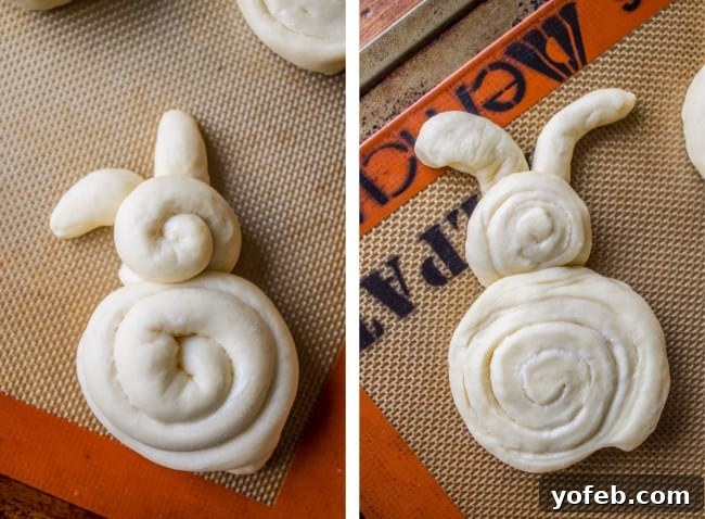 Pillowy Easter Bunny Dinner Rolls 12 Two unbaked Easter Bunny Dinner Rolls shaped from dough, one slightly puffier than the other, both looking cute.