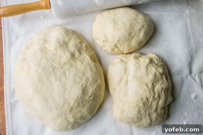 Pillowy Easter Bunny Dinner Rolls 8 Divided dough on a floured surface, with portions designated for bunny bodies, heads, and ears.