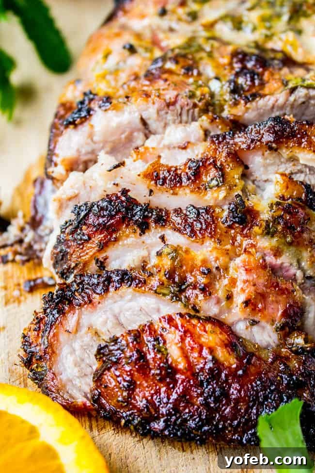 Zesty Cuban Mojo Pork Roast 6 A delicious closeup of roasted Cuban Mojo marinated pork, showing its tender texture and crispy edges.