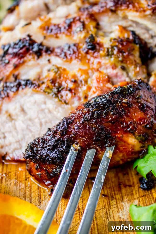 Zesty Cuban Mojo Pork Roast 8 Closeup of roasted Cuban Mojo pork (Lechon Asado) on a fork, showcasing its tender, juicy texture.