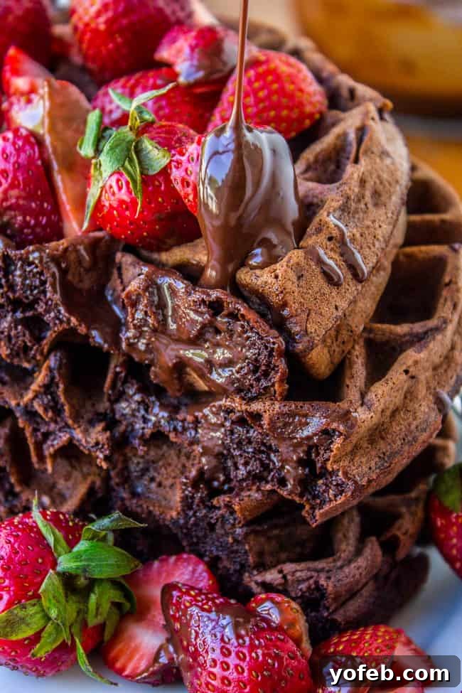 Bittersweet Chocolate Waffles, Ganache-Glazed, with Summer Strawberries 4 Stack of Dark Chocolate Waffles with pouring ganache and fresh strawberries