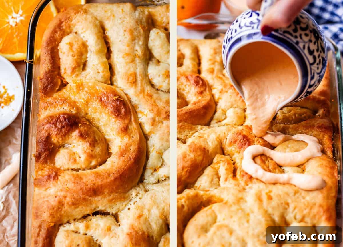 Zesty Orange Sweet Rolls 28 A close-up view of golden brown cinnamon rolls nestled in a baking dish. On the right, a hand gracefully pours creamy orange glaze from a patterned pitcher onto the freshly baked rolls. Slices of vibrant orange and delicate orange zest are visible beside the dish, adding to the allure of the presentation.