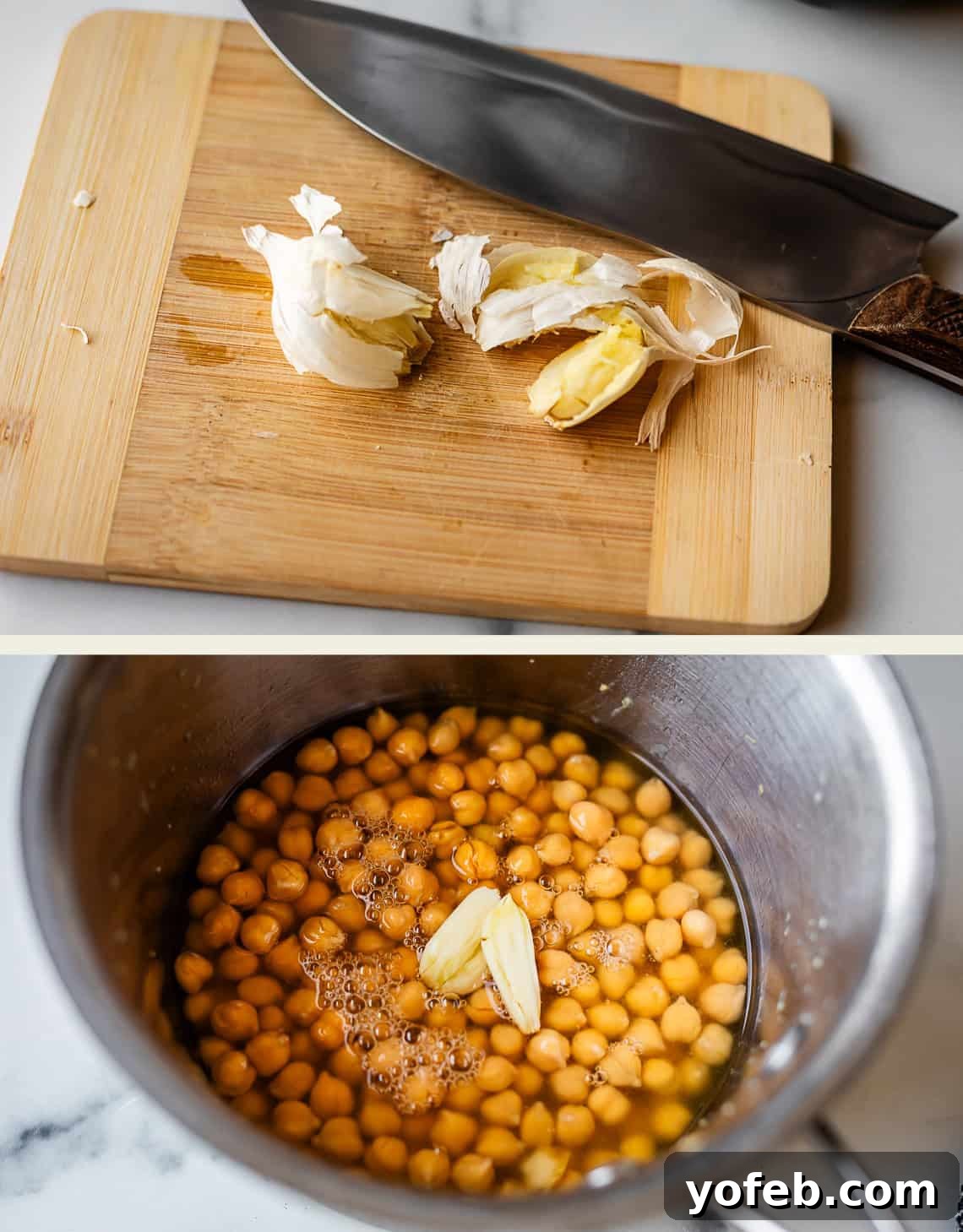 Creamy Homemade Hummus from Scratch: Classic Chickpea Dip Recipe 7 A cutting board with smashed garlic cloves and a knife, above a pot containing chickpeas, water, and pieces of garlic on a marble countertop.