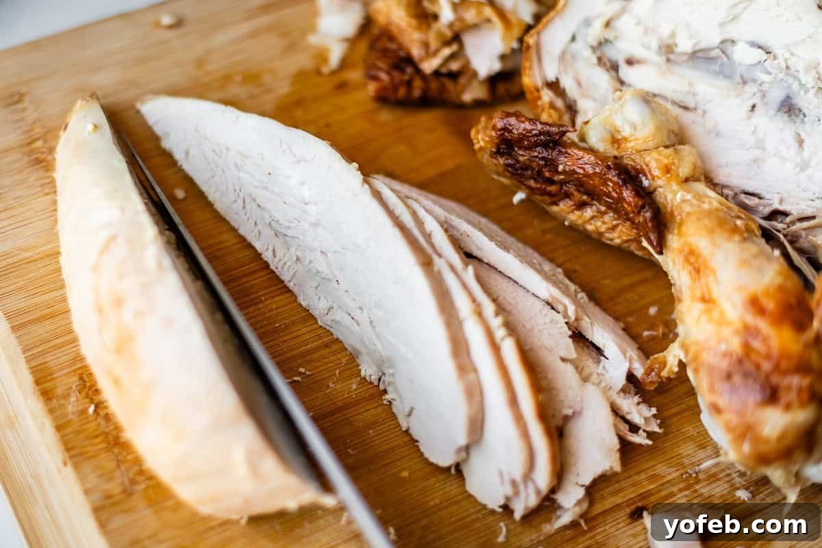 Mendocino Copycat Citrus and Goat Cheese Salad 13 Sliced roasted turkey breast on a wooden cutting board with a knife, showing juicy white meat and crispy brown skin.